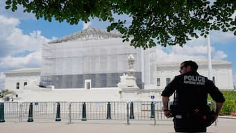 A US Supreme Court police officer stands watch as anti-abortion protesters rally outside of the Supreme Court, on Thursday in Washington. AP