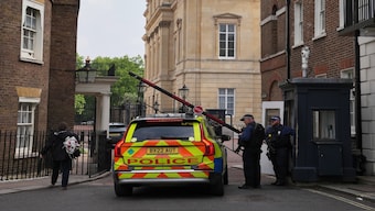 Police officers stand guard at the entrance of Lancaster House, where the trade talks between the US and China are taking place, in London, on Monday.