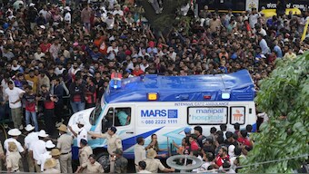An ambulance arrives at the M. Chinnaswamy Stadium as fans gather to celebrate Royal Challengers Bengaluru cricketers, winners of the Indian Premier League, in Bengaluru, June 4, 2025. AP