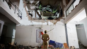 A police officer stands in front of the wreckage of an Air India aircraft, bound for London's Gatwick Airport, which crashed during take-off from an airport in Ahmedabad, June 12, 2025. Reuters