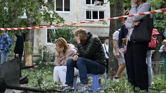 Residents react as Ukrainian rescuers conduct a search and rescue work in a heavily damaged residential building following the Russian missile strike in Kyiv on June 17, 2025, amid the Russian invasion of Ukraine. AFP