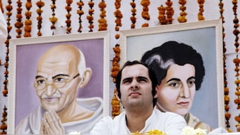 (File) A picture of Sanjay Gandhi taken during a meeting in Avril 1976 in front of portrait of Mahatma Gandhi and of his mother Indira Gandhi.  AFP