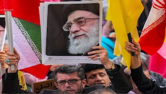 A demonstrator holds a picture of Iran's Supreme Leader Ayatollah Ali Khamenei while gathering with others during a rally in solidarity with the government against Israel's attacks on Iran at Enghelab (Revolution) Square in Tehran. AFP