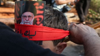 A person carries a picture of Iran's Supreme Leader Ayatollah Ali Khamenei on his forearm in Beirut, Lebanon. Reuters
