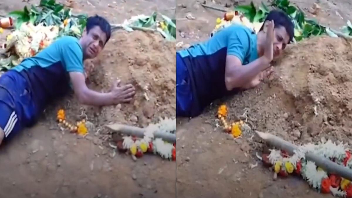 A father cries over son's grave who died in Bengaluru stampede. Image: X/theskindoctor13 A father cries over son's grave who died in Bengaluru stampede. Image: X/theskindoctor13