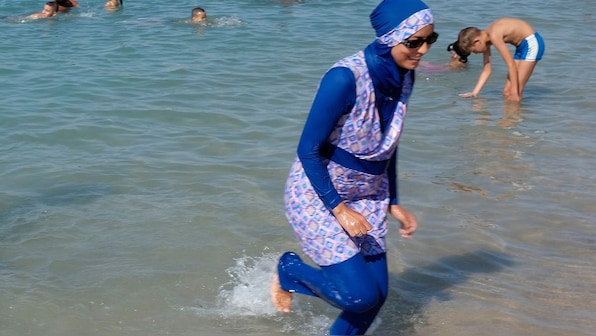 The politics of burkinis: Mandatory for women in Syria, banned in several  European countries – Firstpost