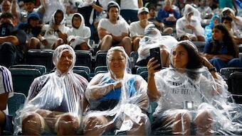 Real Madrid fans shield themselves from the rain inside the stadium before their game in Philadelphia. Image: Reuters