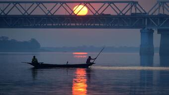 (File) Fishermen steer a boat on the Brahmaputra River at sunset in Guwahati. In his rebuttal to Pakistan's threat, Himanta Biswa Sarma said that China contributes only about 30 to 35 per cent of the Brahmaputra's total flow. Reuters