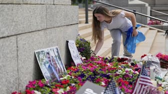 Claire Stein places flowers at a makeshift memorial for Minnesota state Rep. Melissa Hortman and her husband Mark at the state Capitol, Sunday, June 15, 2025, in St. Paul, Minn. AP