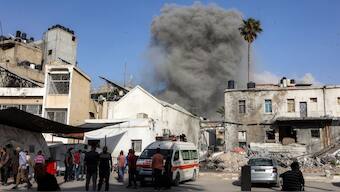 This picture taken from the grounds of the Ahli Arab Hospital, also known as the Maamadani (Baptist) Hospital, shows a cloud of smoke erupting following Israeli bombardment on a building in the Daraj neighbourhood of Gaza City on May 31, 2025. (Source: AFP)