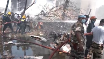 Emergency personnel work at the crash site of an Air India plane in Ahmedabad, India, June 12, 2025, in this still image taken from video. Source: ANI