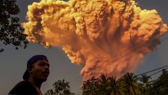A villager watches the eruption of Mount Lewotobi Laki-Laki as seen from Talibura village in Sikka, East Nusa Tenggara, on June 17, 2025. Source: AFP