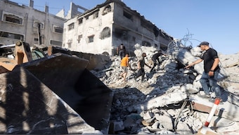 Palestinians search for casualties at the site of an overnight Israeli strike on a fuel station where displaced people shelter, in Gaza City. Reuters
