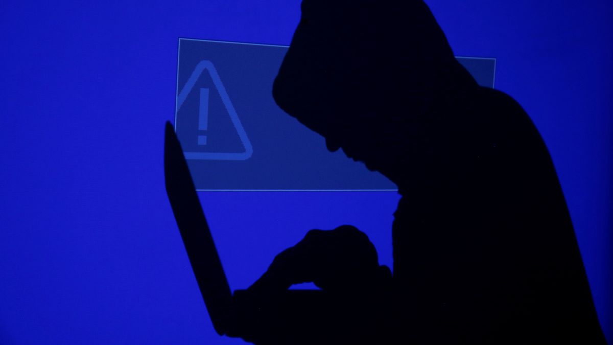 A hooded man holds a laptop computer as blue screen with an exclamation mark is projected on him in this illustration picture taken on May 13, 2017. Representational Image/Reuters A hooded man holds a laptop computer as blue screen with an exclamation mark is projected on him in this illustration picture taken on May 13, 2017. Representational Image/Reuters