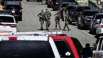Police and fire crews respond to a shooting and fire on Canfield Mountain in Coeur d'Alene, Idaho on Sunday. AP