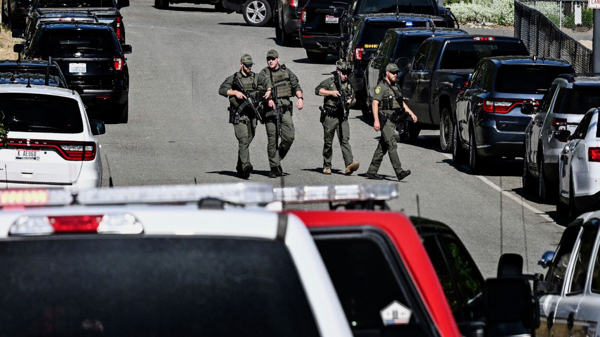 Police and fire crews respond to a shooting and fire on Canfield Mountain in Coeur d'Alene, Idaho on Sunday. AP Police and fire crews respond to a shooting and fire on Canfield Mountain in Coeur d'Alene, Idaho on Sunday. AP