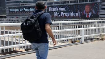 A man walks on a bridge in front of banners bearing a pictures of US President Donald Trump accompanied by a messages, in Tel Aviv. On Monday night, Trump announced that Iran and Israel had agreed to a ceasefire, ending the 12-day war. AFP