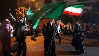 A group of Iranians celebrate following Iran's attack on US military base in Qatar, amid the Iran-Israel conflict, in Tehran, Iran, June 23. After the attack, Donald Trump announced a ceasefire on Truth Social.