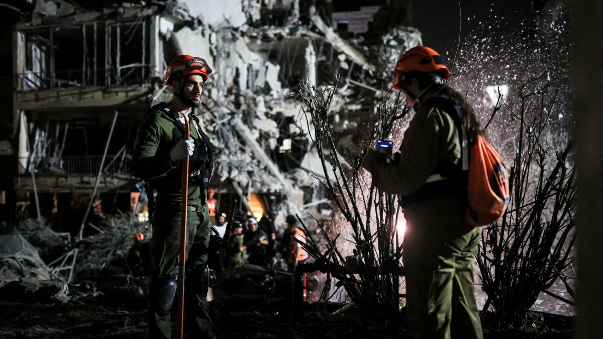 Rescue and security personnel work at an impact site following missile attack from Iran on Israel, in  Ramat Gan, Israel  June 13. Israel says Iran has fired up to 100 missiles in retaliation to Operation Rising Lion. Reuters  Rescue and security personnel work at an impact site following missile attack from Iran on Israel, in  Ramat Gan, Israel  June 13. Israel says Iran has fired up to 100 missiles in retaliation to Operation Rising Lion. Reuters
