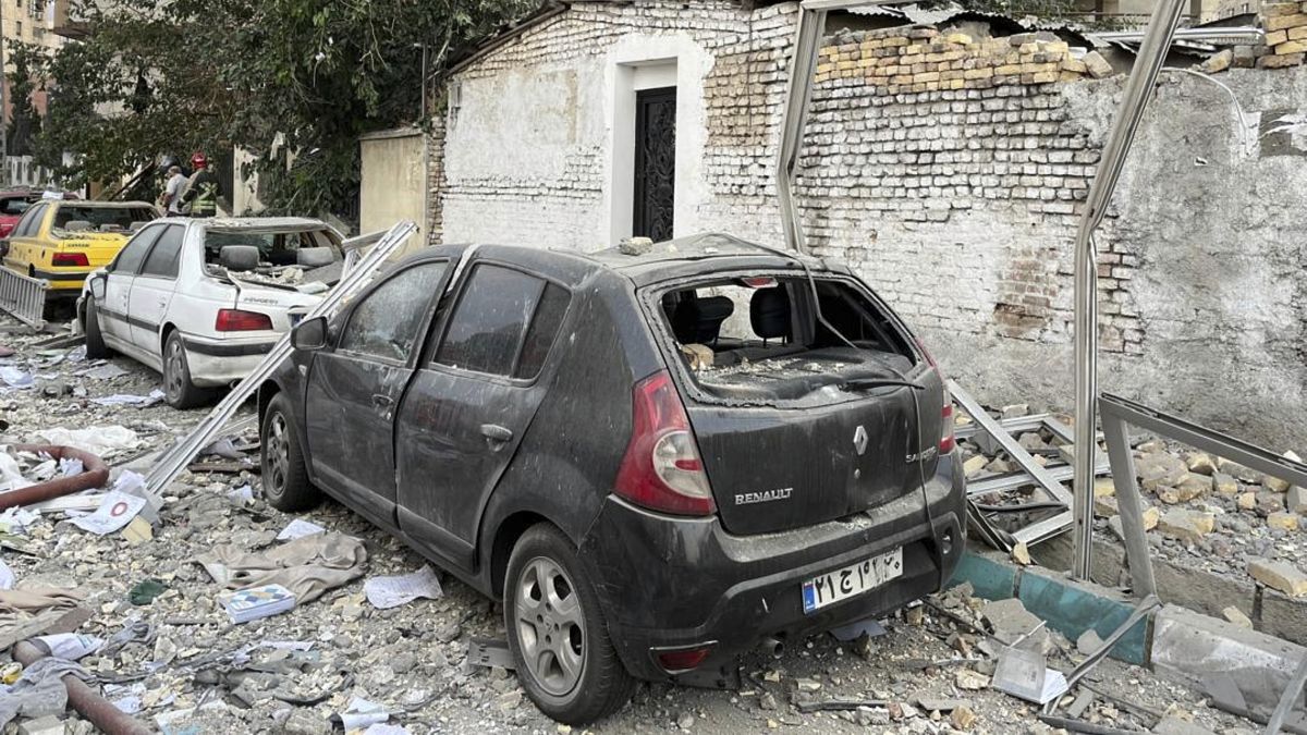 Debris from an apartment building is seen on top of parked cars after a strike in Tehran, Iran, early Friday, June 13, 2025. Israel attacked Iran's capital early Friday, with explosions booming across Tehran.(AP Photo/Vahid Salemi) Debris from an apartment building is seen on top of parked cars after a strike in Tehran, Iran, early Friday, June 13, 2025. Israel attacked Iran's capital early Friday, with explosions booming across Tehran.(AP Photo/Vahid Salemi)