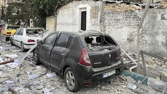 Debris from an apartment building is seen on top of parked cars after a strike in Tehran, Iran, early Friday, June 13, 2025. Israel attacked Iran's capital early Friday, with explosions booming across Tehran.(AP Photo/Vahid Salemi)