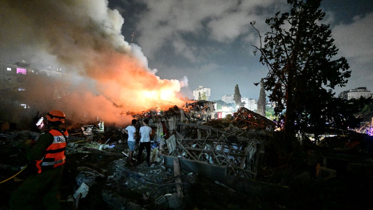 Locals look at the fire at an impact site following missile attack from Iran on Israel, at central Israel June 15. The two sides have been trading strikes as the conflict escalates. Reuters Locals look at the fire at an impact site following missile attack from Iran on Israel, at central Israel June 15. The two sides have been trading strikes as the conflict escalates. Reuters