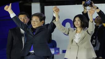 South Korea's new President Lee Jae-myung, left, and his wife Kim Hea Kyung greet supporters outside of the National Assembly in Seoul, South Korea. AP