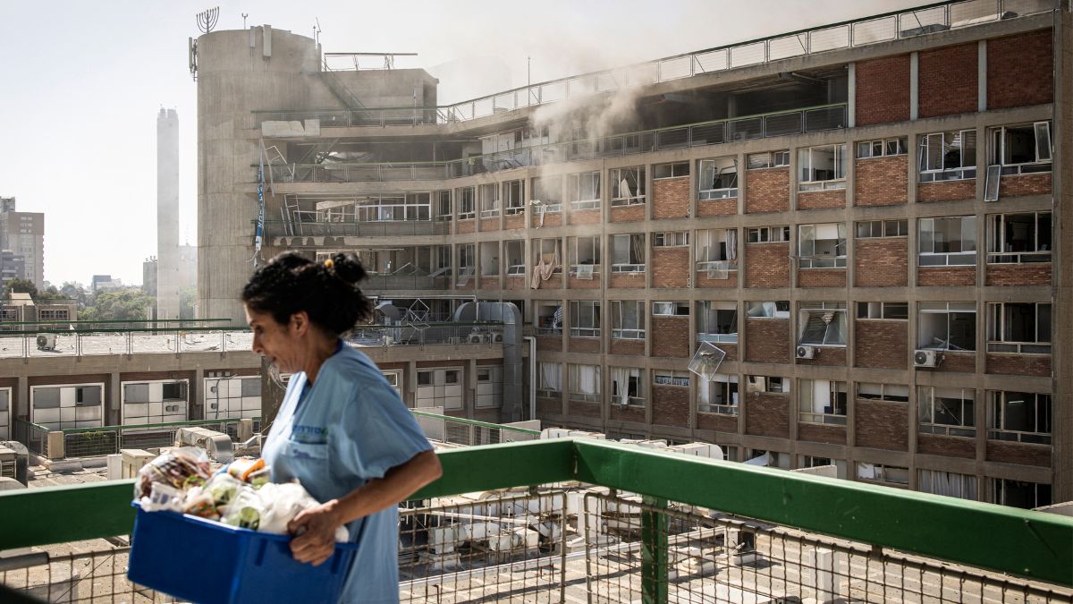 A nurse carries medical supplies past a building with smoke billowing out at Soroka Hospital following an Iranian missile attack in Beersheba in southern Israel on June 19, 2025. AFP A nurse carries medical supplies past a building with smoke billowing out at Soroka Hospital following an Iranian missile attack in Beersheba in southern Israel on June 19, 2025. AFP