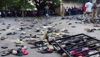 Fans stand next to abandonned shoes and a fallen barrier following a stampede during celebrations, a day after Royal Challengers Bengaluru's victory at the Indian Premier League (IPL), outside the M Chinnaswamy Stadium in Bengaluru. AFP