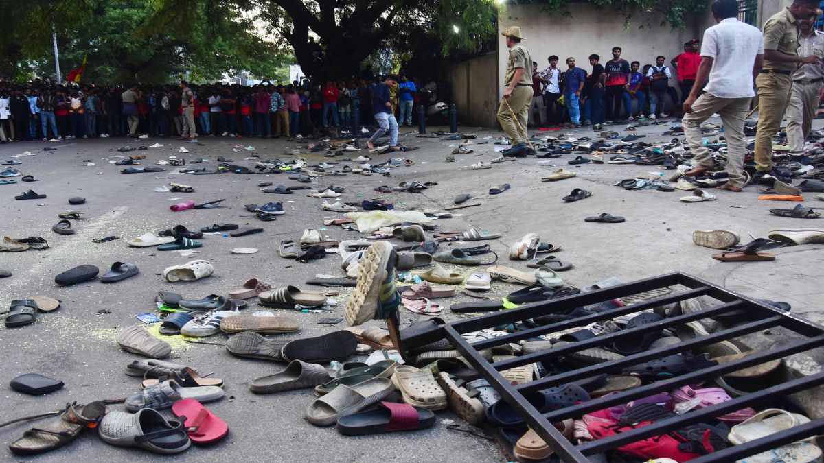 Fans stand next to abandonned shoes and a fallen barrier following a stampede during celebrations, a day after Royal Challengers Bengaluru's victory at the Indian Premier League (IPL), outside the M Chinnaswamy Stadium in Bengaluru. AFP Fans stand next to abandonned shoes and a fallen barrier following a stampede during celebrations, a day after Royal Challengers Bengaluru's victory at the Indian Premier League (IPL), outside the M Chinnaswamy Stadium in Bengaluru. AFP