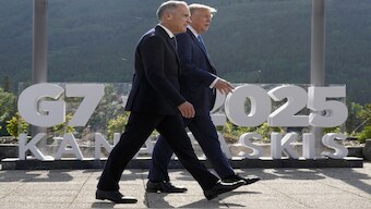 Canadian Prime Minister Mark Carney walks with US President Donald Trump. AP