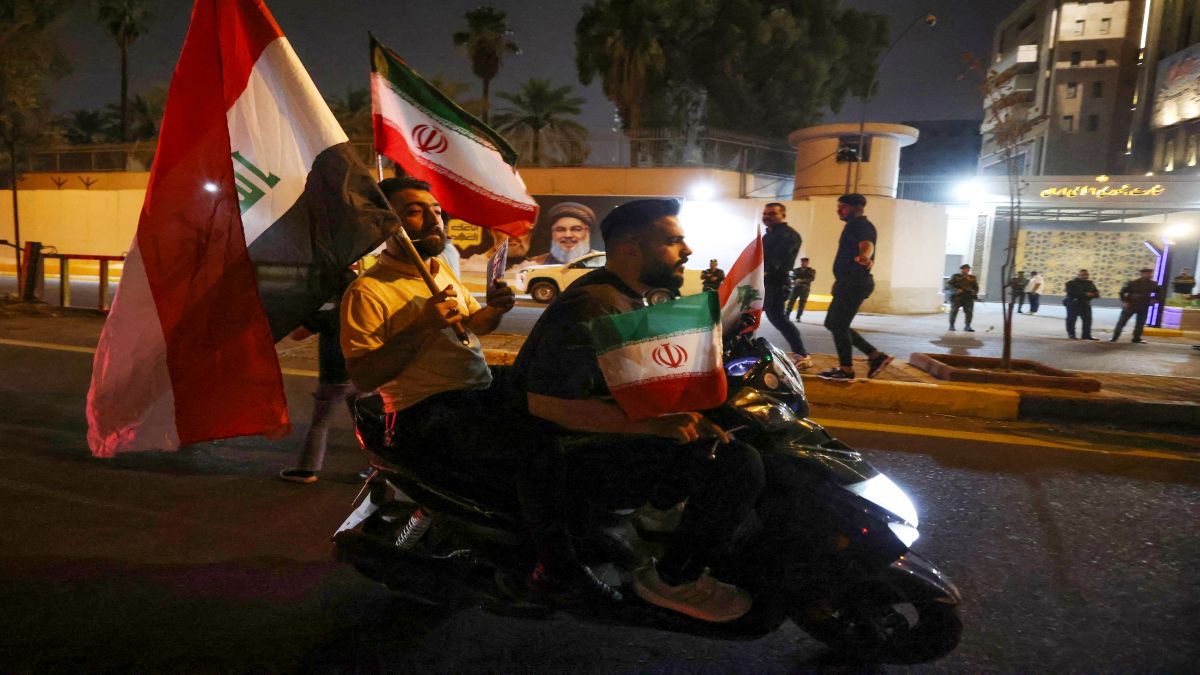People riding on a moped wave Iraqi and Iranian flags as they celebrate in front of the Iranian embassy in Baghdad, following a ceasefire between Israel and Iran. Israel and Iran said they had agreed to US President Donald Trump's proposal for a ceasefire, on the 12th day of war between the foes. AFP People riding on a moped wave Iraqi and Iranian flags as they celebrate in front of the Iranian embassy in Baghdad, following a ceasefire between Israel and Iran. Israel and Iran said they had agreed to US President Donald Trump's proposal for a ceasefire, on the 12th day of war between the foes. AFP