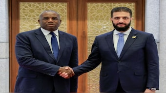 Syria's interim president, Ahmed al-Sharaa, (right) welcomes the UK’s foreign secretary, David Lammy, in the Syrian capital, Damascus. AFP