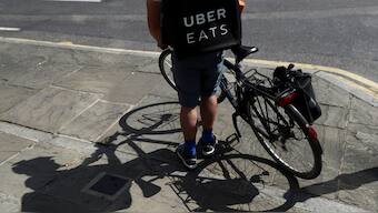 A cyclist prepares to delivery an Uber Eats food order in London, Britain. Reuters