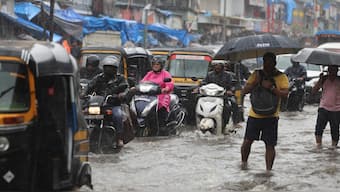 Traffic moves on a waterlogged road amid heavy rain in Mumbai, India. Reuters
