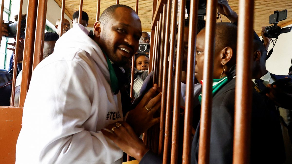 Kenyan human rights activist Boniface Mwangi talks to his wife Njeri Mwangi from a steel caged dock after he was charged with unlawful possession of ammunition over his alleged role in deadly anti-government protests in June, at the Kahawa Law Courts in Kiambu County, Kenya July 21, 2025. Reuters Kenyan human rights activist Boniface Mwangi talks to his wife Njeri Mwangi from a steel caged dock after he was charged with unlawful possession of ammunition over his alleged role in deadly anti-government protests in June, at the Kahawa Law Courts in Kiambu County, Kenya July 21, 2025. Reuters