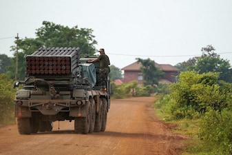 A Cambodian military personnel stands on a BM-21 Grad multiple rocket launcher, around 40 km (24 miles) from the disputed Ta Moan Thom temple, after Thailand and Cambodia exchanged heavy artillery on Friday. Reuters