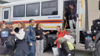Evacuees walk out of a truck as rescuers relocate them to a safe area due to the tsunami threat following a powerful earthquake, in the region of Kamchatka, Russia. Reuters