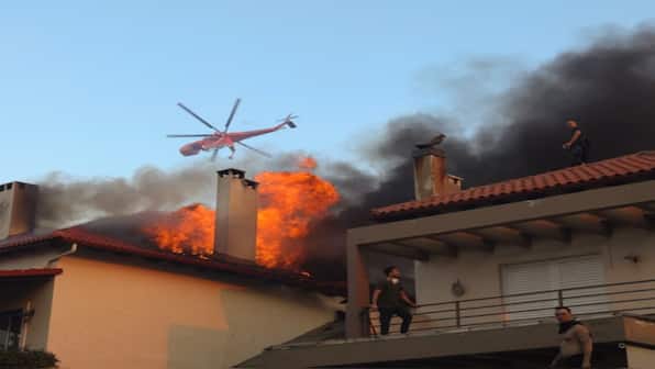 Massive wildfires engulf northern suburb of Athens as Greece reels through horrors of climate change