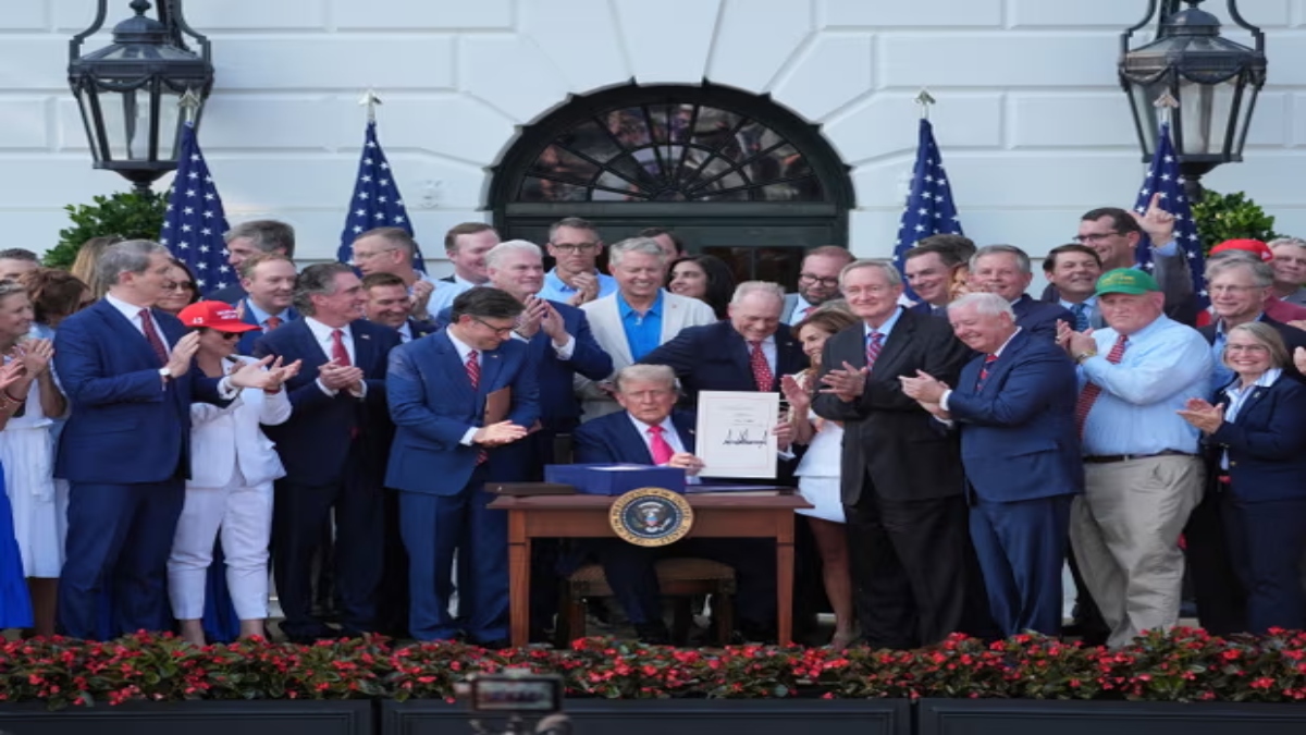 Donald Trump signs his signature bill of tax breaks and spending cuts at the White House on Friday in Washington, surrounded by members of Congress. AP Donald Trump signs his signature bill of tax breaks and spending cuts at the White House on Friday in Washington, surrounded by members of Congress. AP