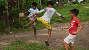 Bhutanese refugee children play football in the Beldangi refugee camp in Damak, some 300 km south-east of Kathmandu. AFP
