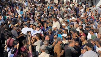 Mourners walk in the funeral procession of Palestinians killed in Israeli strikes on the southern Gaza Strip the previous day, outside the Nasser Hospital in Khan Yunis on July 4, 2025. AFP
