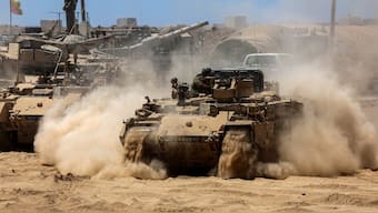 Israeli troops deploy by Israel's border fence with the Gaza Strip. AFP