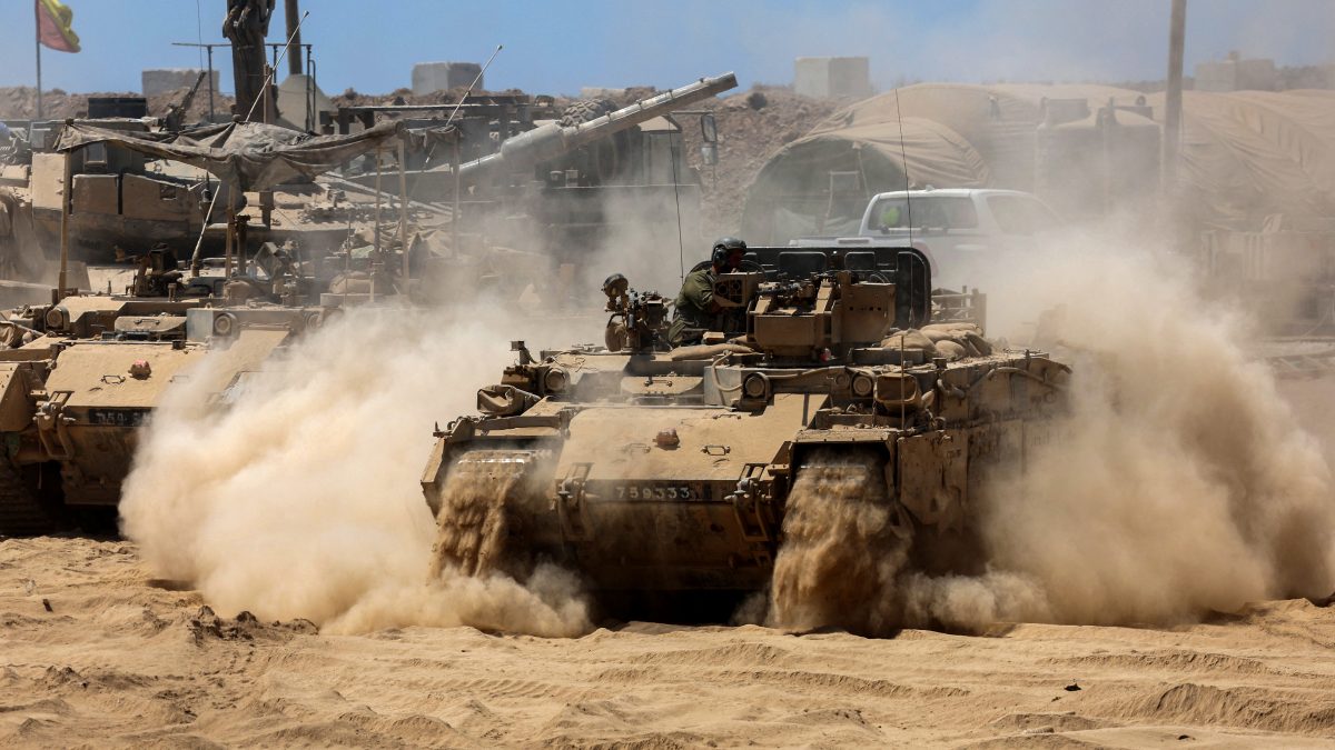 Israeli troops deploy by Israel's border fence with the Gaza Strip. AFP Israeli troops deploy by Israel's border fence with the Gaza Strip. AFP