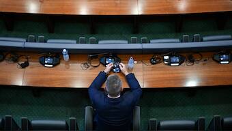 A member of Kosovo's Parliament looks at his phone during a session in the plenary hall of the Kosovo parliament in Pristina on July 13, 2025. Kosovo MPs failed on July 21, 2025 to elect a speaker and constitute a new parliament for the fiftieth consecutive time, continuing a political stalemate months after they were voted into office. AFP