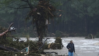 A man surveys debris along the Guadalupe River after a flash flood struck the area, Friday, July 4, 2025, in Kerrville, Texas. AP 

