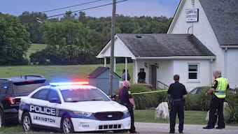 Police stand at the front of the Richmond Road Baptist Church as other officers maintain a perimeter following a shooting at the church in Lexington, Ky. AP