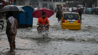 Motorists drive through a flooded road during monsoon rainfall, in Rawalpindi,. AP
