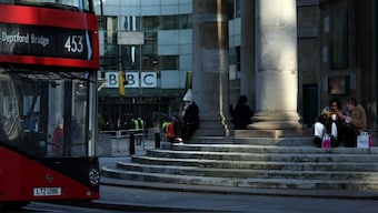 People sit outside the BBC Broadcasting House offices and recording studios in London, UK, January 17, 2022. File Image/Reuters