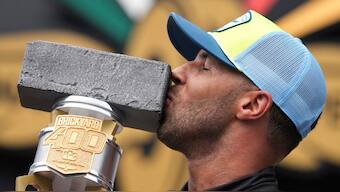 Bubba Wallace kisses the trophy after winning a NASCAR Cup Series auto race at Indianapolis Motor Speedway. Image: AP 
